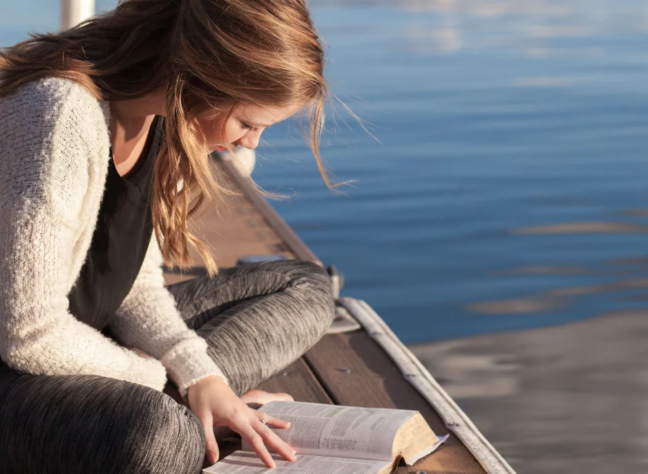 Woman reading at seaside